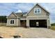 Charming new home featuring neutral siding, white trim, and an attached two-car garage for comfortable parking at 141 Noramac Ct, Selma, NC 27576