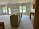 Unfinished kitchen with cabinets and island, offering an open floor plan that transitions to the outdoor patio at 141 Noramac Ct, Selma, NC 27576