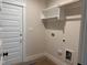 Functional laundry room with storage and utility connections at 141 Noramac Ct, Selma, NC 27576