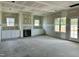 Unfinished living room featuring a classic fireplace and built-in cabinets for ample storage on both sides at 141 Noramac Ct, Selma, NC 27576