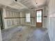 A well-lit living room with paneled wainscoting and a contemporary door at 141 Noramac Ct, Selma, NC 27576