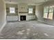 Bright living room featuring a fireplace, built-in shelving and plenty of natural light at 141 Noramac Ct, Selma, NC 27576