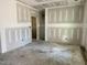 Spacious unfinished living room offers versatile layout options, with a view to the rest of the home at 141 Noramac Ct, Selma, NC 27576