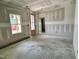 Unfinished living room features a window offering views and a doorway leading to other rooms in the house at 141 Noramac Ct, Selma, NC 27576