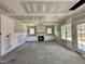 A well-lit living room with fireplace, built-ins and large windows at 141 Noramac Ct, Selma, NC 27576