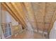 Unfinished attic with visible beams and wooden walls. Great storage space at 154 Ashton Ln, Angier, NC 27501