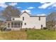 Spacious backyard featuring a screened-in porch, fence, and lush green grass at 154 Ashton Ln, Angier, NC 27501