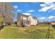 Exterior view of the house showing the expansive, grassy backyard at 154 Ashton Ln, Angier, NC 27501