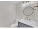 Bathroom features vanity with modern fixtures and round mirror at 154 Ashton Ln, Angier, NC 27501