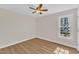 Bright bedroom features wood floors and a window with a view of the backyard at 154 Ashton Ln, Angier, NC 27501