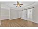 Spacious bedroom features wood floors, modern ceiling fan, and a barn door to the bathroom at 154 Ashton Ln, Angier, NC 27501