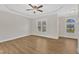 Empty bedroom showcasing a tray ceiling, wood floors and windows at 154 Ashton Ln, Angier, NC 27501