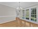 Inviting dining room with hardwood floors, large windows, and stylish lighting, perfect for Gathering meals at 154 Ashton Ln, Angier, NC 27501
