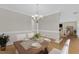 Dining room with a wooden table adorned with dinnerware, accompanied by cushioned chairs, fostering a welcoming setting at 154 Ashton Ln, Angier, NC 27501