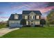 Beautiful two-story home featuring a manicured lawn and classic architectural details at dusk at 154 Ashton Ln, Angier, NC 27501