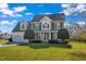 Charming two-story home features a well-kept lawn, a two-car garage, and mature landscaping at 154 Ashton Ln, Angier, NC 27501