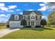 Charming two-story home with a well-manicured lawn, two-car garage, and attractive landscaping at 154 Ashton Ln, Angier, NC 27501