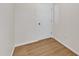Hallway leading to an adjacent room features a white door and wood floors at 154 Ashton Ln, Angier, NC 27501