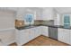 Spacious kitchen with white cabinets, stainless appliances, hardwood floors, and granite counters at 154 Ashton Ln, Angier, NC 27501