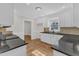Modern kitchen showcasing ample granite countertops, white cabinetry, and seamless transition into the dining area at 154 Ashton Ln, Angier, NC 27501