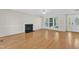 Inviting living room offers wood floors, a fireplace, and large windows at 154 Ashton Ln, Angier, NC 27501