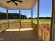 Covered back porch with a view of the meadow and forest offers a peaceful outdoor space at 163 Noramac Ct, Selma, NC 27576