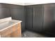 Stylish bathroom showcasing modern fixtures and elegant black wainscoting at 163 Noramac Ct, Selma, NC 27576