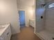 Beautiful bathroom with a glass enclosed walk-in shower, a black shower head, and tiled walls at 163 Noramac Ct, Selma, NC 27576