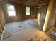 Unfinished bedroom with stud walls, two windows providing natural light, and subflooring at 163 Noramac Ct, Selma, NC 27576