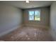 Neutral bedroom with a window providing natural light, ready for personalization at 163 Noramac Ct, Selma, NC 27576