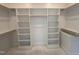 Walk-in closet with custom built in shelves and hanging racks at 163 Noramac Ct, Selma, NC 27576