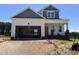 Charming new construction home with a two car garage, a mix of siding colors, and an unfinished front yard at 163 Noramac Ct, Selma, NC 27576