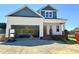 New two-story home featuring a two-car garage and a classic facade with blue and white accents at 163 Noramac Ct, Selma, NC 27576