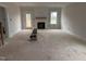 Spacious living room with a fireplace and a doorway leading to the exterior at 163 Noramac Ct, Selma, NC 27576