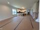 Open concept living room and kitchen with lots of natural light and views of the entry staircase at 163 Noramac Ct, Selma, NC 27576