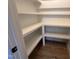 Walk in pantry with white shelves and ample storage space for all your food and kitchen supply needs at 163 Noramac Ct, Selma, NC 27576