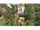 Aerial view showcasing a home with deck surrounded by lush, mature trees at 170 Buckaroo Dr, Louisburg, NC 27549