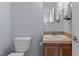 Powder room featuring toilet and sink with neutral walls and tile backsplash at 170 Buckaroo Dr, Louisburg, NC 27549