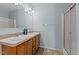 Bathroom with a double sink vanity, decorative light fixtures and a walk-in shower with a glass door at 170 Buckaroo Dr, Louisburg, NC 27549