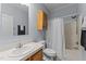 Bathroom with wood cabinet, sink, toilet, and tub/shower combo at 170 Buckaroo Dr, Louisburg, NC 27549