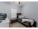Simple bedroom with hardwood floors, a window, and a modern computer setup at 170 Buckaroo Dr, Louisburg, NC 27549