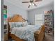 Cozy bedroom with a decorative bed frame, white bookcase, and ceiling fan at 170 Buckaroo Dr, Louisburg, NC 27549