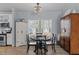 Bright dining area features a table with seating for four people in front of windows overlooking the yard at 170 Buckaroo Dr, Louisburg, NC 27549