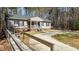 Ranch home with a ramp leading to the covered front porch and a long, curving driveway at 170 Buckaroo Dr, Louisburg, NC 27549
