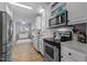 Well-lit kitchen features white cabinets, stainless steel appliances, and ample counter space for cooking at 170 Buckaroo Dr, Louisburg, NC 27549