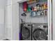 Functional laundry room with washer, dryer, and shelving for ample storage at 170 Buckaroo Dr, Louisburg, NC 27549