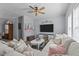 Cozy living room with comfortable sofa, ceiling fan, TV, and stylish decor, creating a welcoming atmosphere at 170 Buckaroo Dr, Louisburg, NC 27549