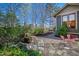 Tranquil backyard features a rock water feature, stone pathway, lush landscaping, and outdoor seating for relaxation at 1714 Park Dr, Raleigh, NC 27605