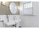 Charming bathroom with white tile walls, modern fixtures, and natural light at 1714 Park Dr, Raleigh, NC 27605