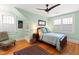 Cozy bedroom with hardwood floors, a ceiling fan, and two windows providing ample natural light at 1714 Park Dr, Raleigh, NC 27605
